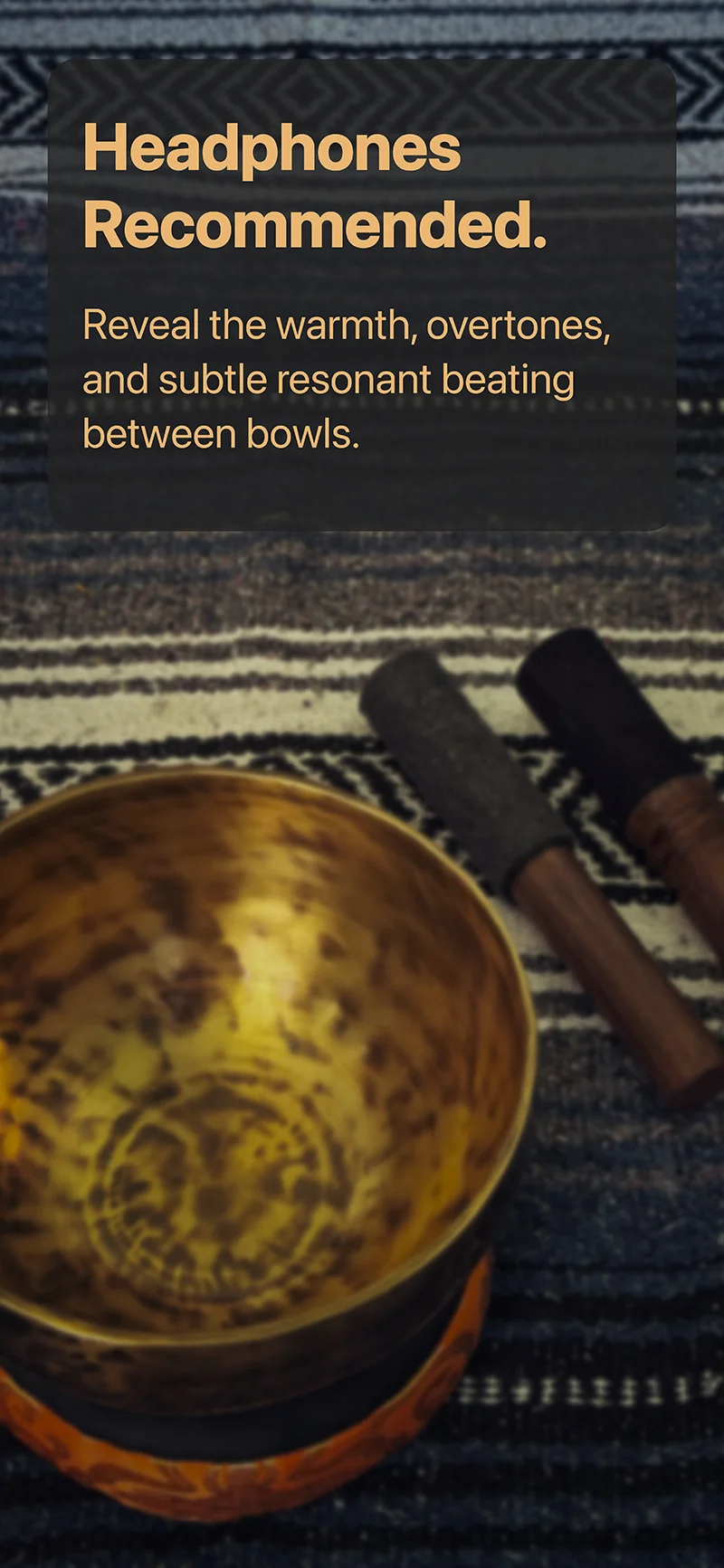 Close-up of a hand hammered Himalayan singing bowl and meditation mallets highlighting natural overtones and resonant beating best heard with headphones.