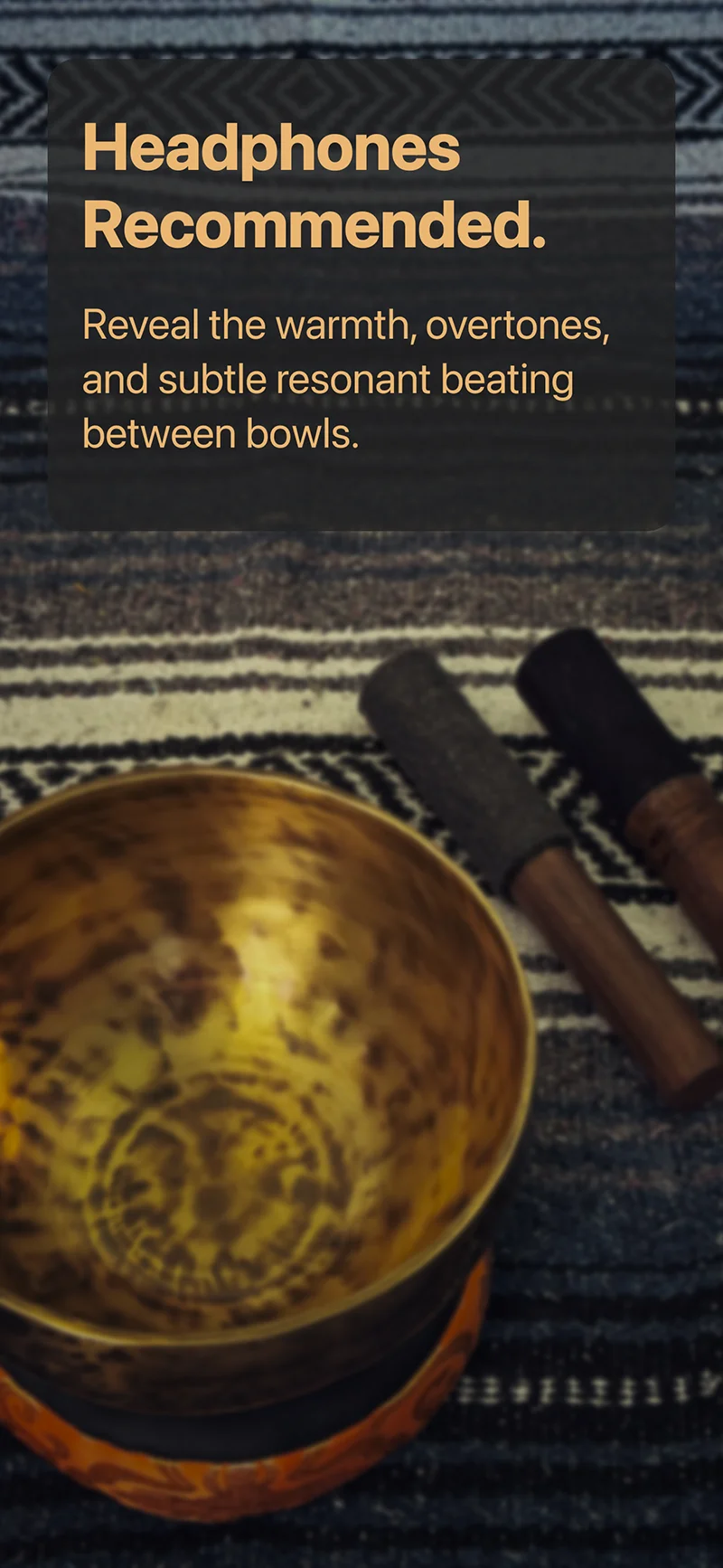 Close-up of a hand hammered Himalayan singing bowl and meditation mallets highlighting natural overtones and resonant beating best heard with headphones.